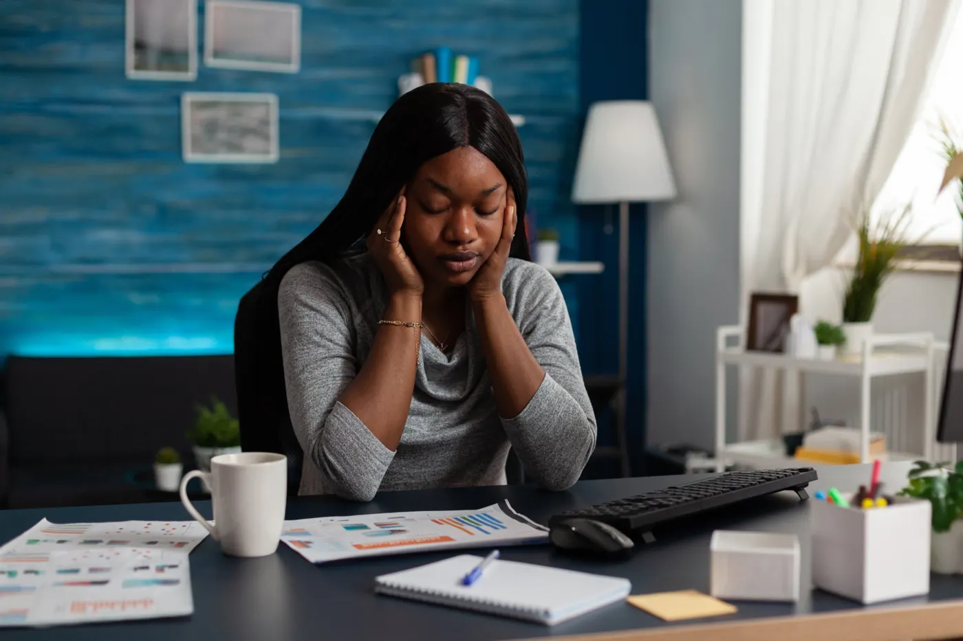 Small business owner stressed at her desk with a stalled computer
